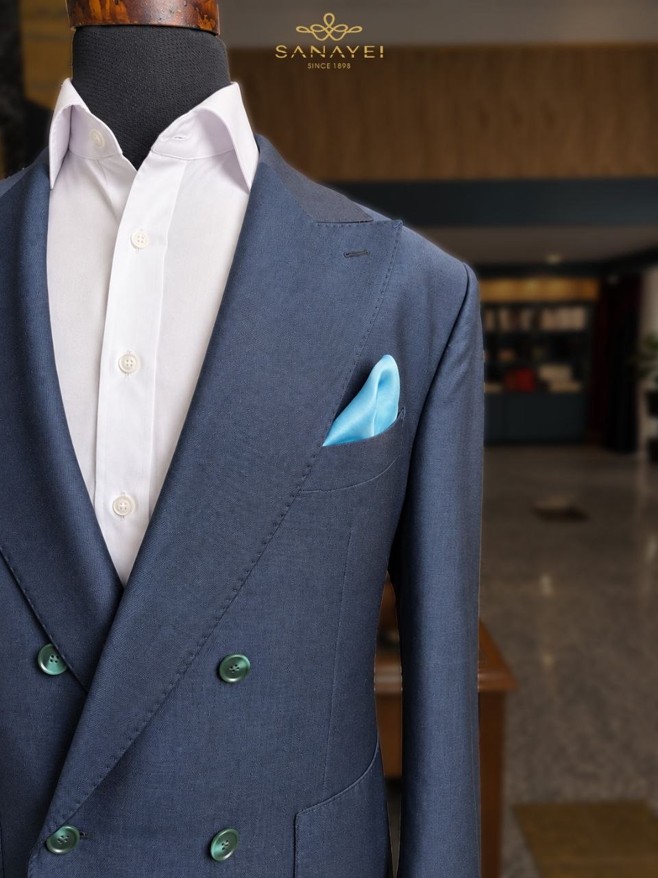 A navy double-breasted jacket, with green buttons